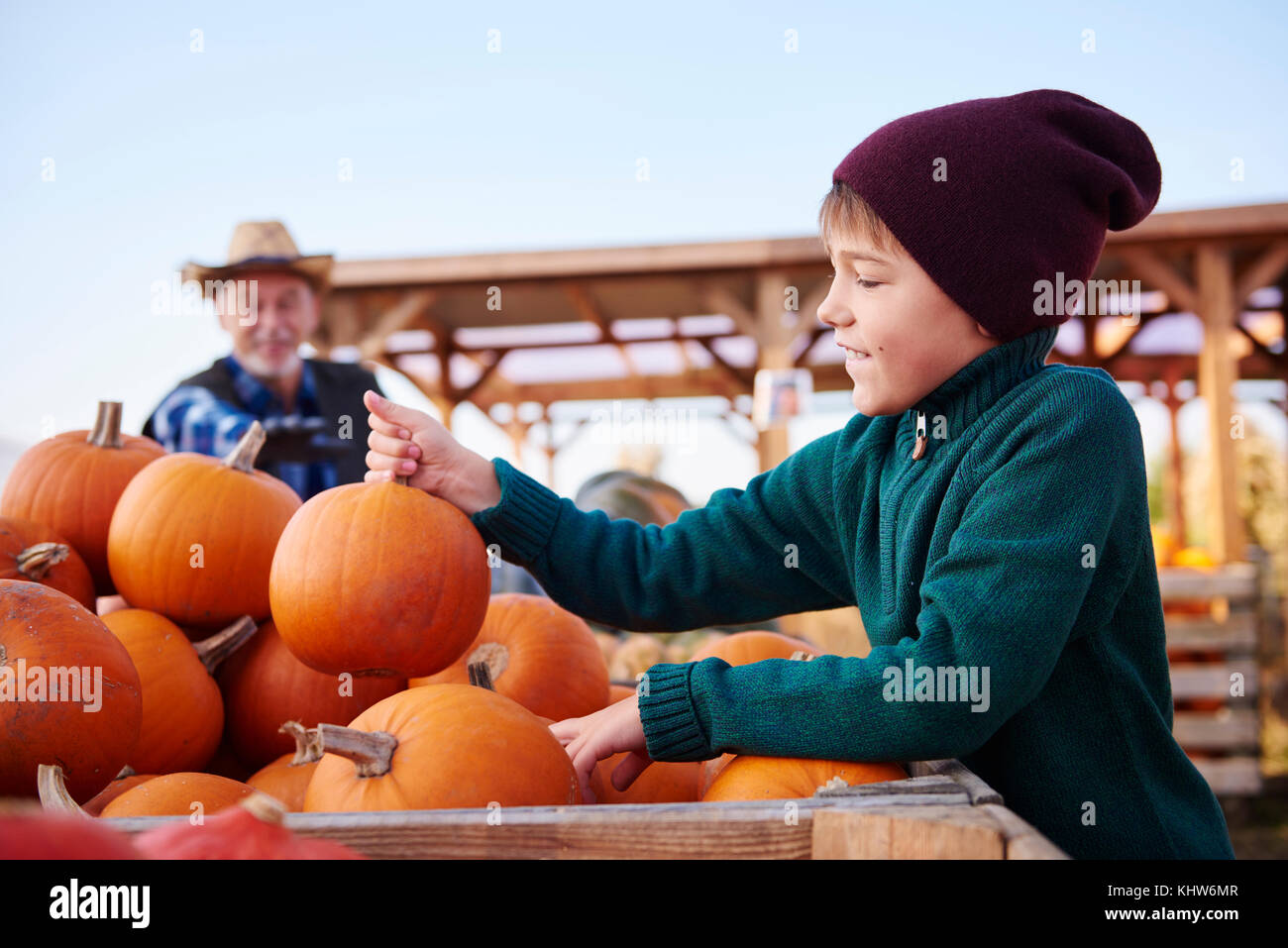 Farmer and grandson at pumpkin farm Stock Photo