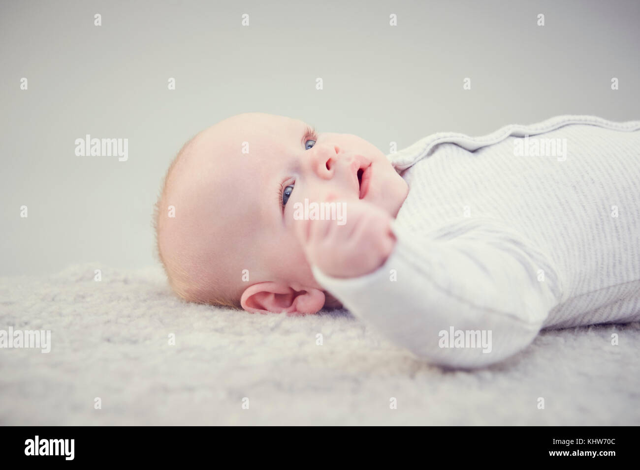 Newborn baby boy, lying on rug, close-up Stock Photo
