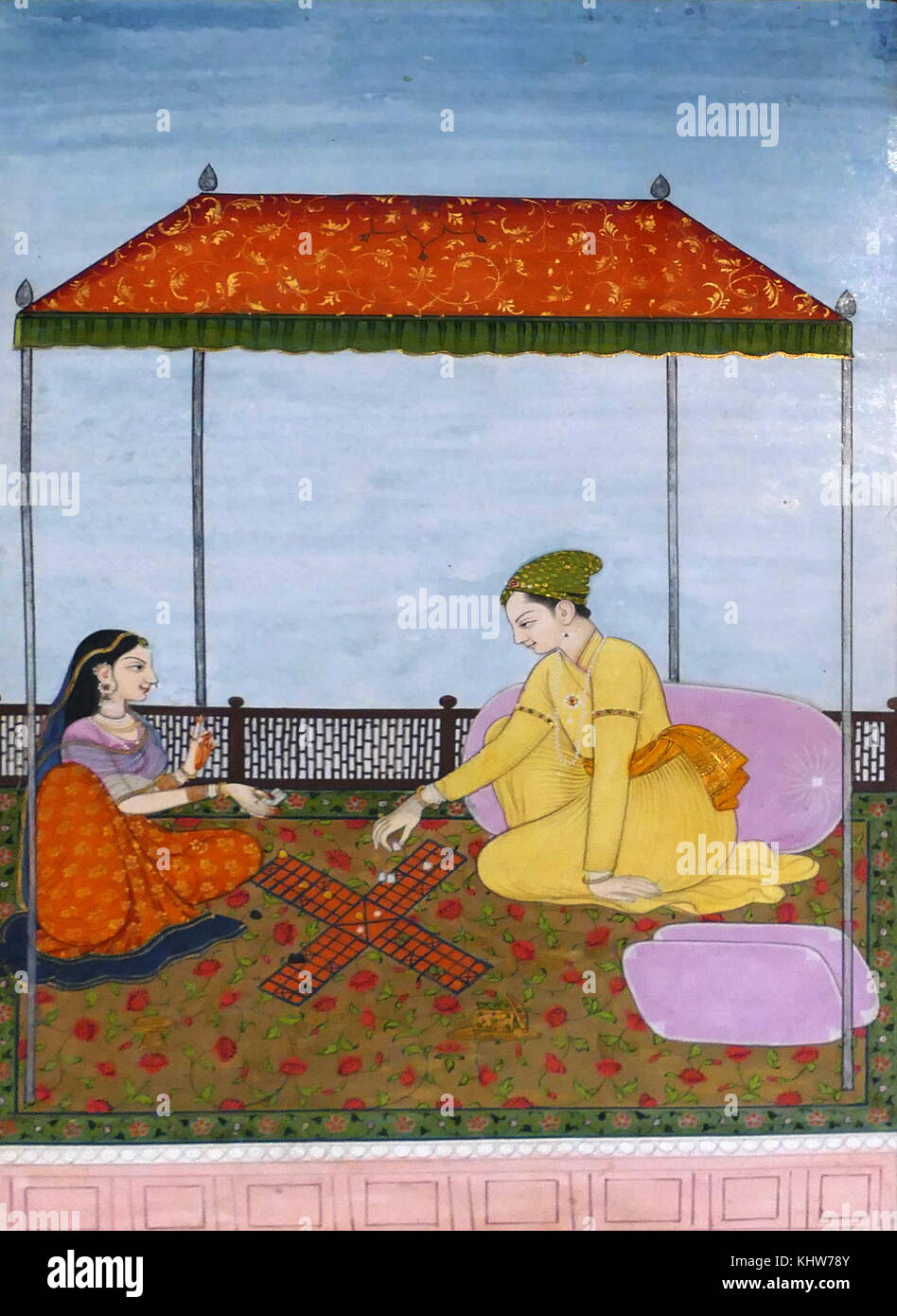 Painting depicting a couple playing Chaupar. Chaupar is a cross and circle board game played in India. Dated 18th Century Stock Photo