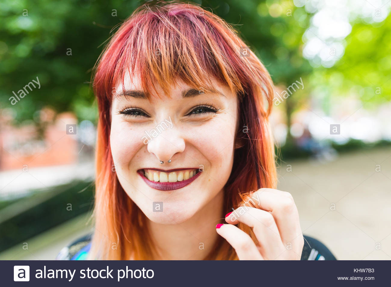 Portrait Of Young Woman With Dip Dyed Hair In Park Stock