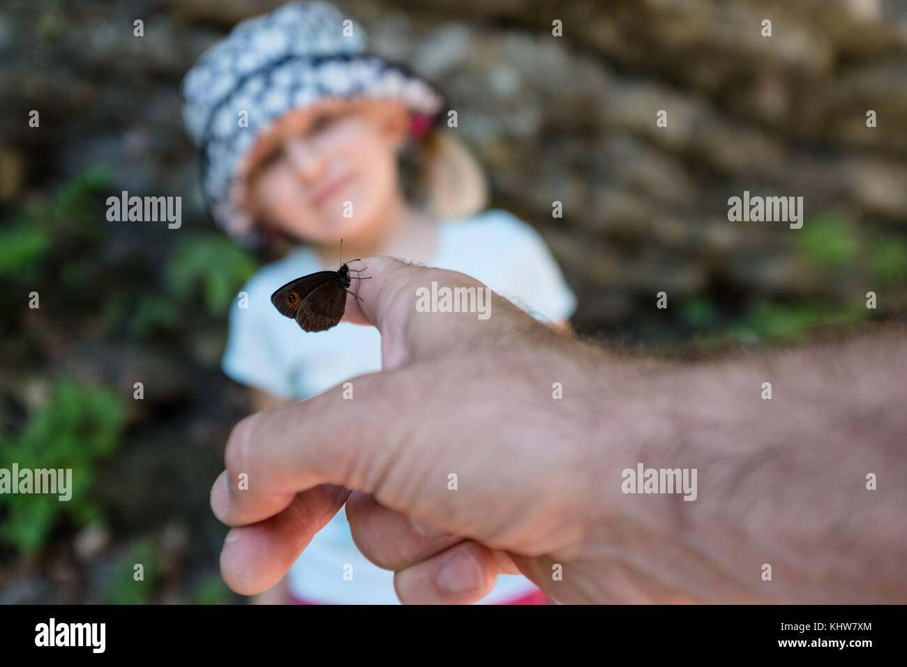 A 5yrs old girl watchnig a butterfly Stock Photo