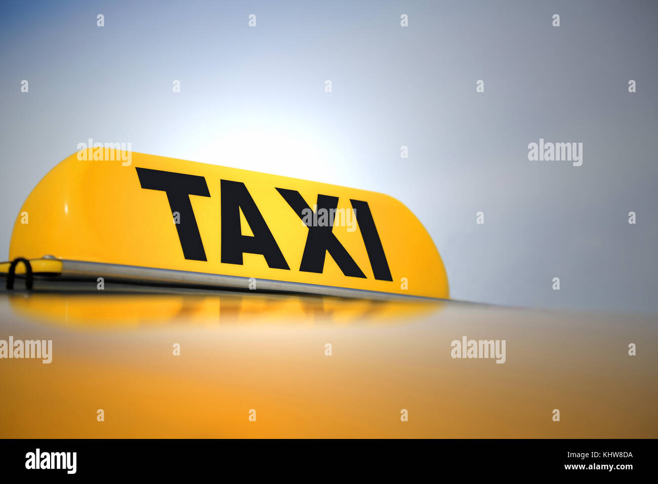 Illuminated Taxi sign on yellow cab. Copy space, shallow depth of field. Stock Photo