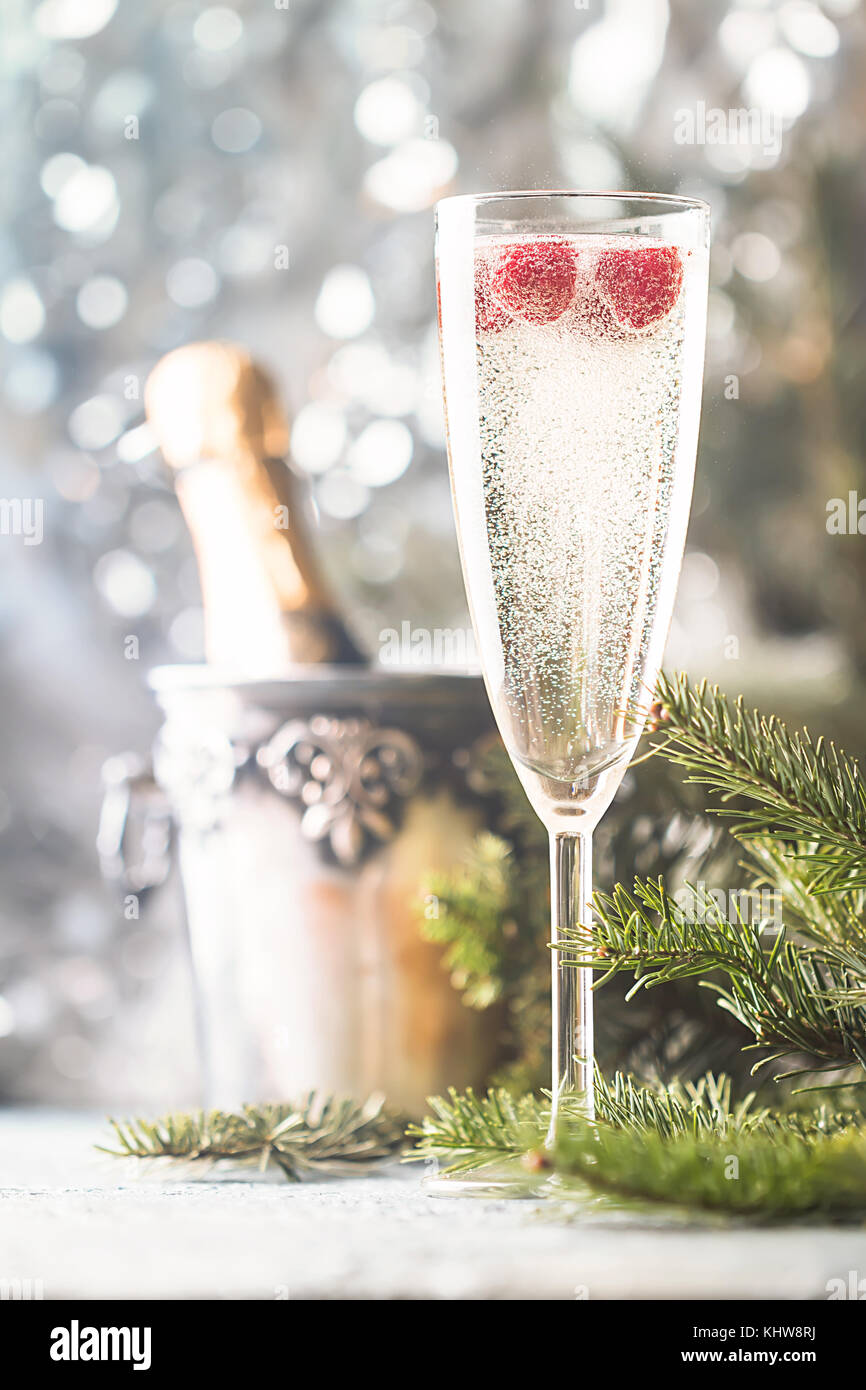 Sparkling Raspberry Champoagne Champagne glass with raspberry and a bottle of chompagne on sparkling ...