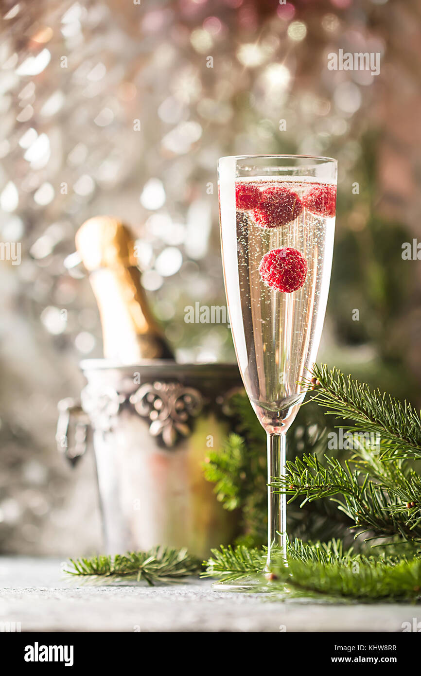 Sparkling Raspberry Champoagne Champagne glass with raspberry and a bottle of chompagne on sparkling ...