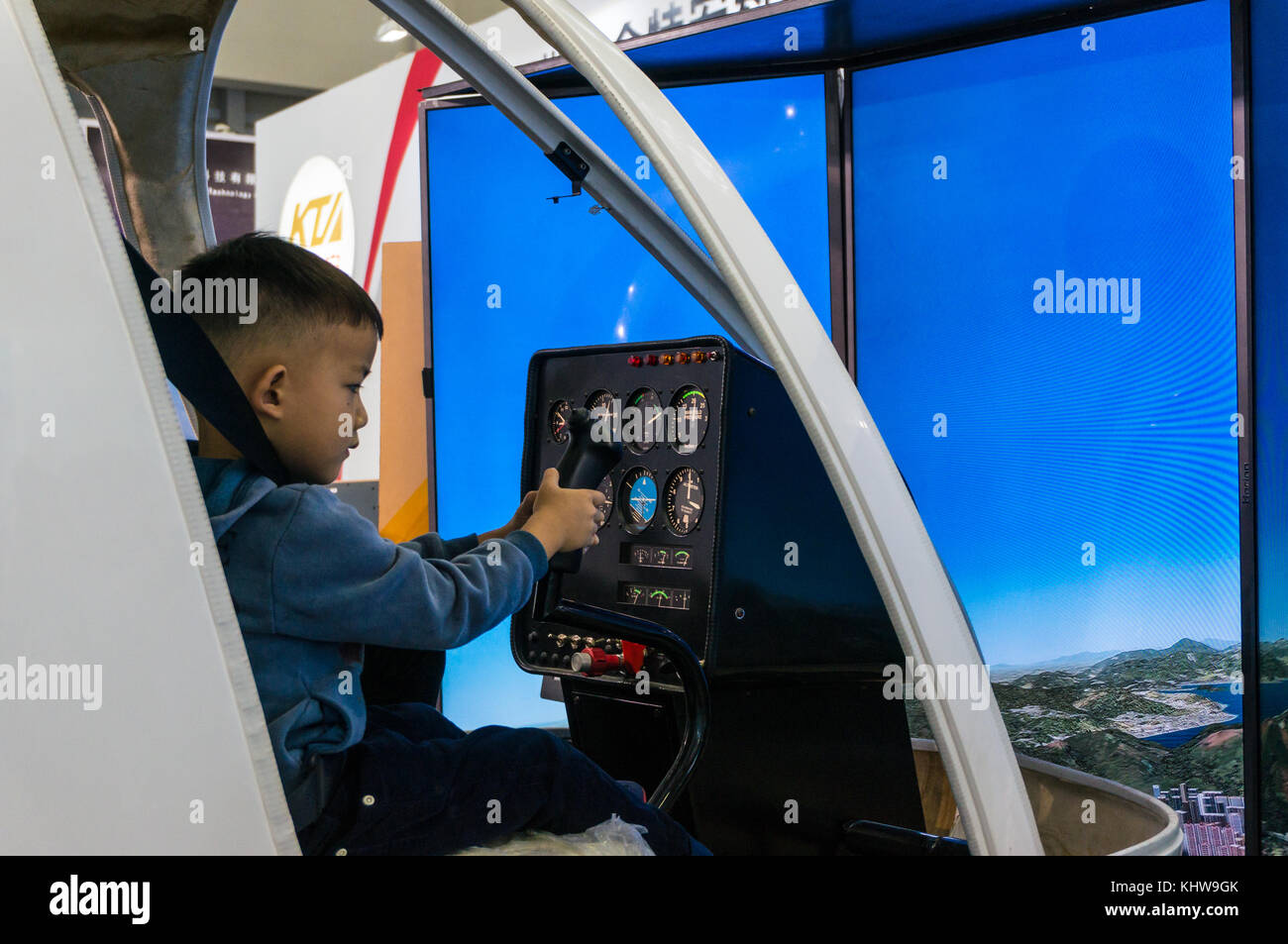 Boy and helicopter flight training simulator, hands on education Stock Photo