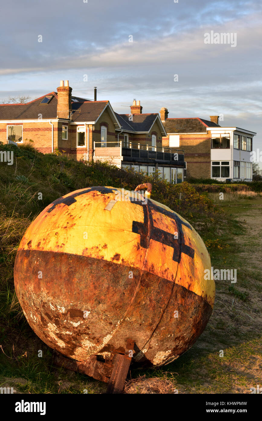 Arusty old yellow round metal navigation buoy high and dry wash up on