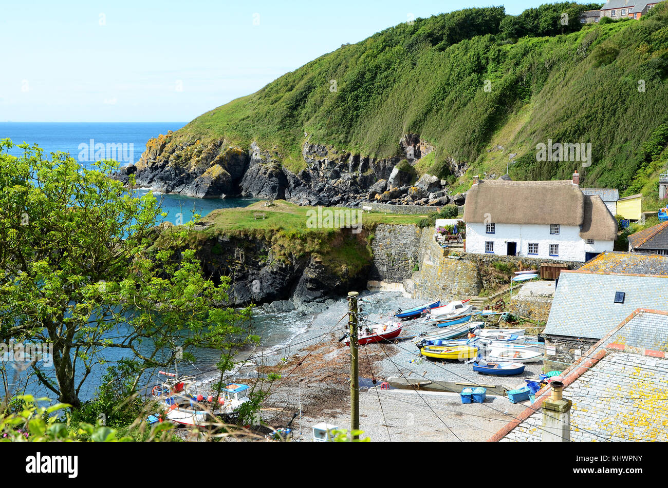 fishing boats and cottages at cadgwith cove on the lizard peninsular in cornwall, england, uk. Stock Photo