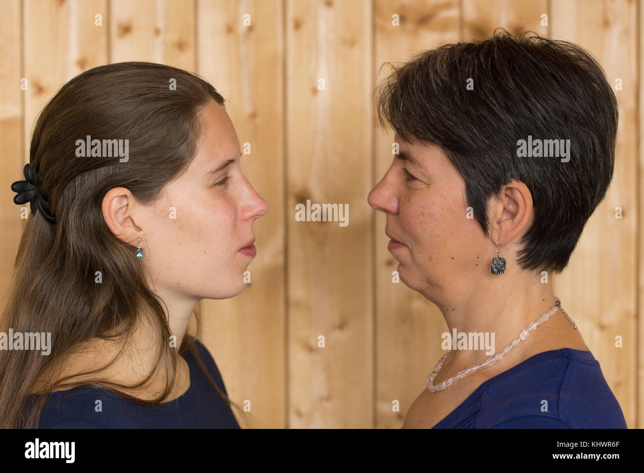 A mother and daughter staring and angry with each other Stock Photo
