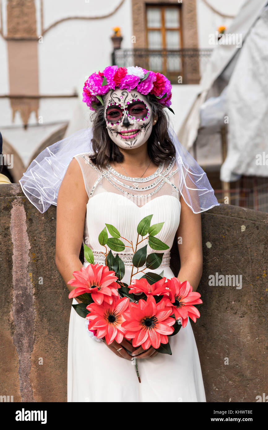 A young woman dressed in La Calavera Catrina bride costume during the Day  of the Dead or Día de Muertos festival October 31, 2017 in Patzcuaro,  Michoacan, Mexico. The festival has been