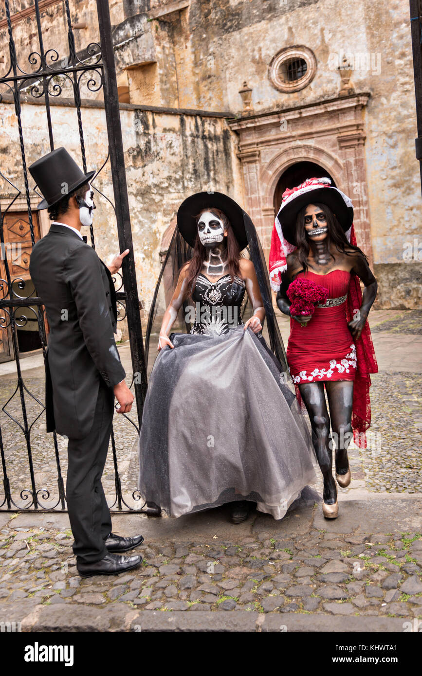 Mexican teens dressed in La Calavera Catrina and Dapper Skeleton costumes  for the Day of the Dead or Día de Muertos festival October 31, 2017 in  Patzcuaro, Michoacan, Mexico. The festival has