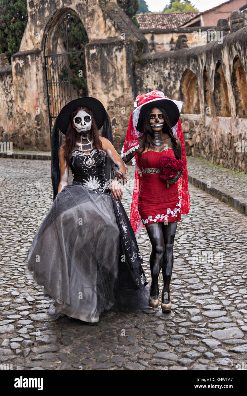 Young Mexican women dressed in La Calavera Catrina costumes at the Templo  del Sagrario during the Day of the Dead or Día de Muertos festival October  31, 2017 in Patzcuaro, Michoacan, Mexico.