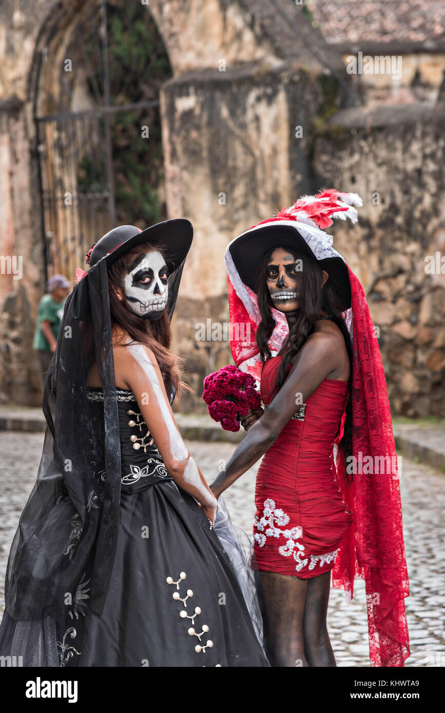Young Mexican women dressed in La Calavera Catrina costumes at the Templo  del Sagrario during the Day of the Dead or Día de Muertos festival October  31, 2017 in Patzcuaro, Michoacan, Mexico.