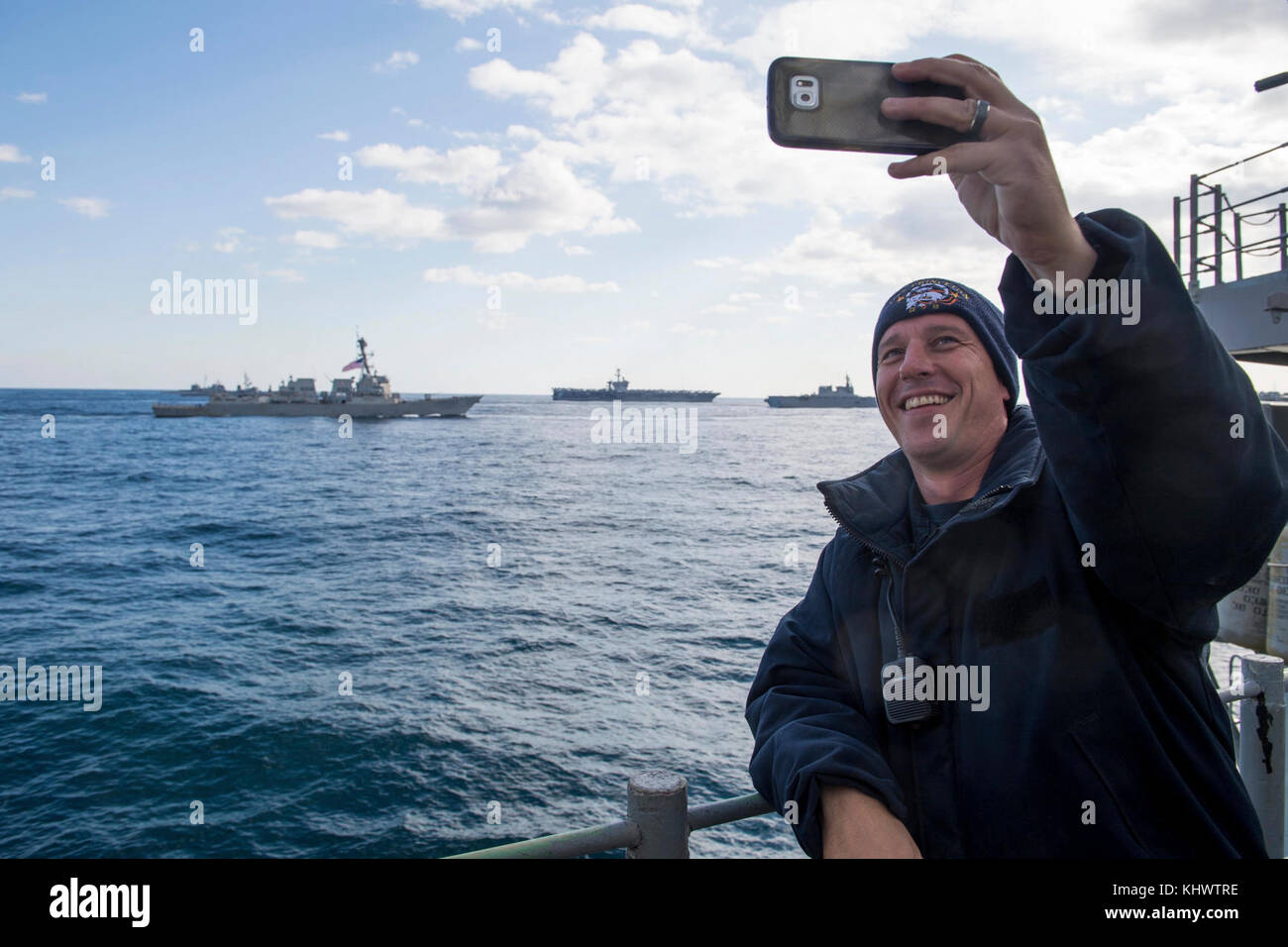 171112-N-VR594-0008 WESTERN PACIFIC (Nov. 12, 2017)  Fire Controlman Aegis 2nd Class Sean Loughlin, from Brooklyn, N.Y., takes a selfie from the Ticonderoga-class guided-missile cruiser USS Princeton (CG 59) as the U.S. Navy and Japan Maritime Self-Defense Force ships conduct a three-carrier strike force photo exercise. The USS Ronald Reagan (CVN 76), USS Theodore Roosevelt (CVN 71) and USS Nimitz (CVN 68) Strike Groups are underway and conducting operations in international waters as part of a three-carrier strike force exercise. The U.S. Navy has patrolled the Indo-Asia Pacific region routin Stock Photo