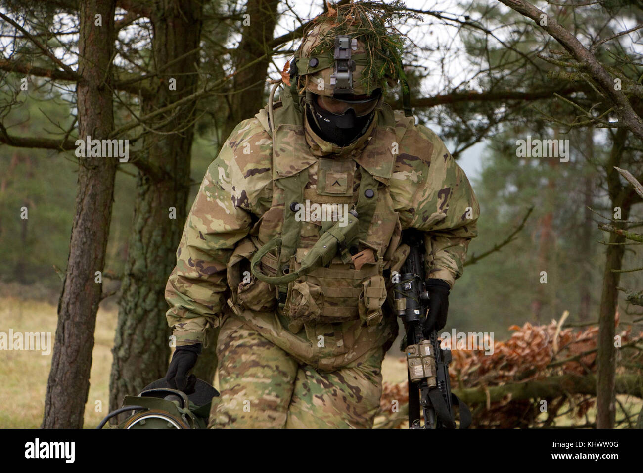 A Soldier from 1st Squadron, 2d Cavalry Regiment changes his fighting position while taking part in a battle against opposing forces during Allied Spirit VII at the 7th Army Training Command's Hohenfels Training Area, Germany, Oct. 30 to Nov. 22, 2017. Allied Spirit is a U.S. Army Europe-directed, 7ATC-conducted multinational exercise series designated to develop and enhance NATO nations interoperability and readiness. Stock Photo