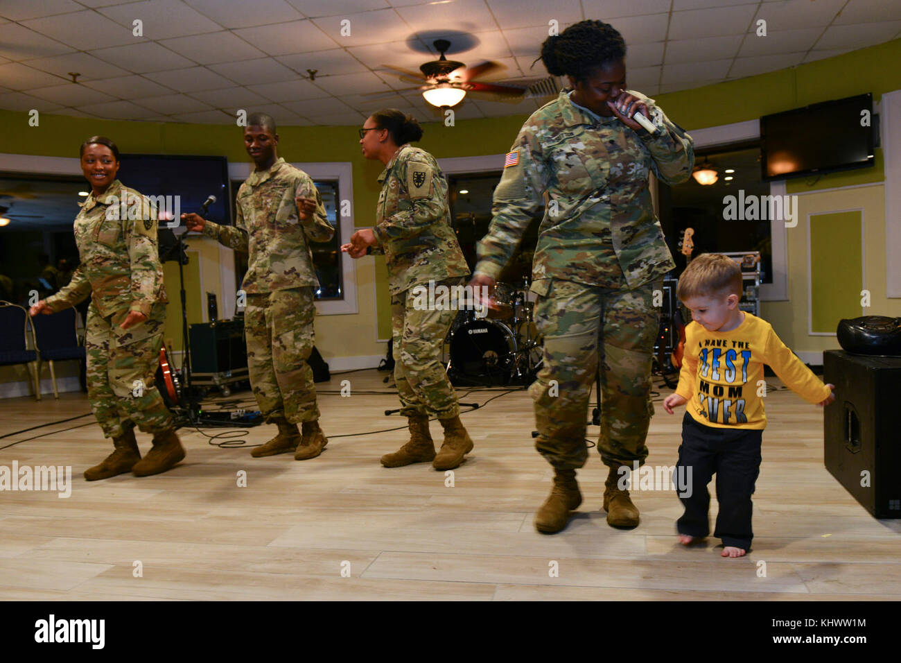 From left, U.S. Army Privates 1st Class Christian Everett and Keshawn Jones, Specialists Victoria Porter and Jalisa Sutton, Better Opportunities for Single Soldiers (BOSS) members, perform with 2-year-old Jadon Keller, Gold Star family member, during the seventh annual “Thanks for Giving” holiday social for Gold Star families talent show at Joint Base Langley-Eustis, Va., Nov. 16, 2017. The event was hosted by Survivor Outreach Services to let Gold Star families know their sacrifice is not forgotten. (U.S. Air Force photo by Tech. Sgt. Katie Gar Ward) Stock Photo