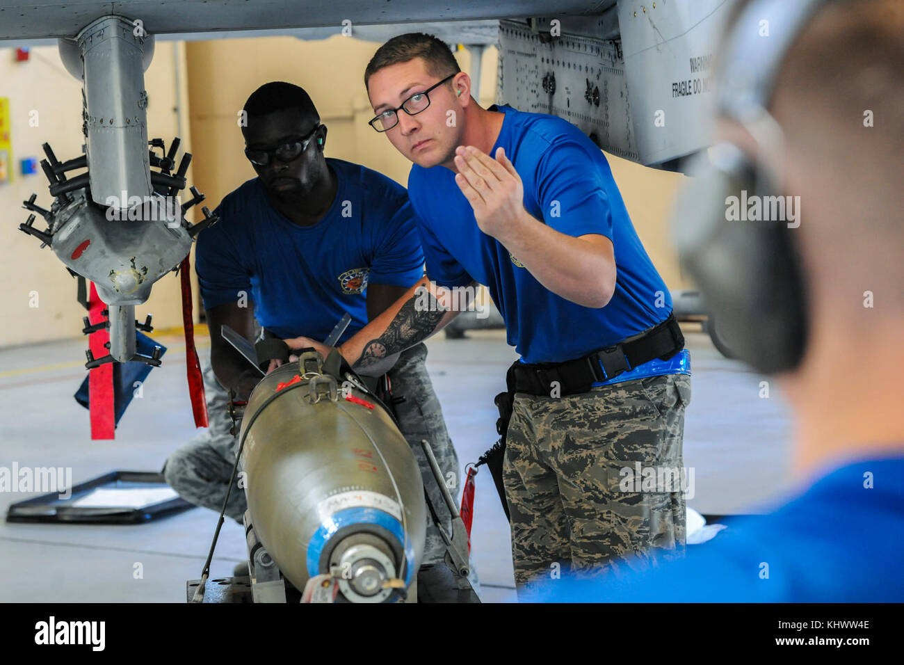 Members of the 74th Aircraft Maintenance Unit prepare to load a MK84 bomb on an A-10C Thunderbolt II, during a quarterly weapons load competition, Nov. 16, 2017, at Moody Air Force Base, Ga. Judges evaluated the competitors based on dress and appearance, a knowledge exam and loading various munitions to determine the swiftest and most efficient load crew. (U.S. Air Force photo by Airman Eugene Oliver) Stock Photo