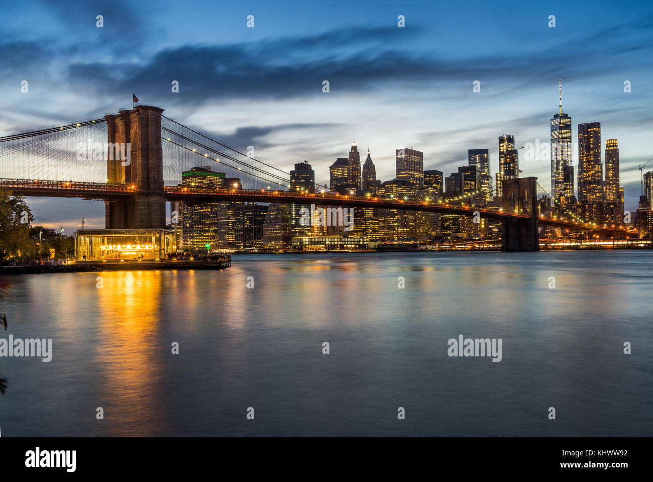 Evening view of Illuminated Downtown Manhattan with Brooklyn Bridge from Brooklyn Dumbo area Stock Photo