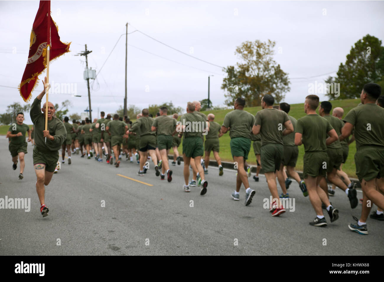 Cpl. Rosember Gloria, a maintenance data specialist with 4th Marine Aircraft Wing, Marine Forces Reserve, runs with a guide-on, alongside Marines from multiple MARFORRES units with Marine Corps Support Facility New Orleans, during a motivational run in New Orleans, Nov. 9, 2017. The 3-mile run is held annually to celebrate the Marine Corps birthday, and promote unit cohesion and esprit de corps. (U.S. Marine Corps photo by PFC. Tessa D. Watts) Stock Photo