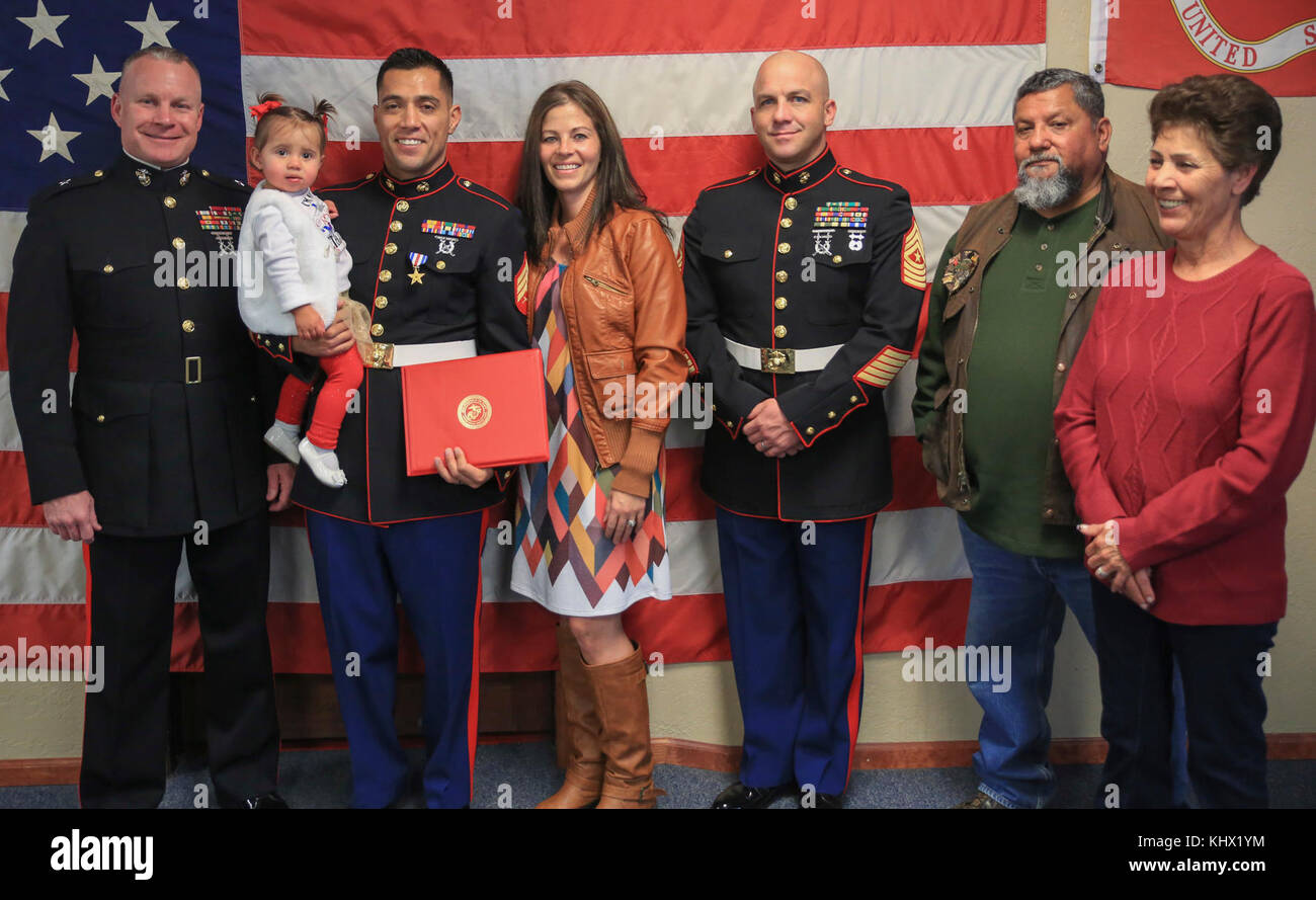 Brig Gen. Michael Martin (far left), deputy commanding general of Marine Corps Forces Command, Sgt. Eubaldo Lovato, Silver Star recipient, and Sgt. Maj. Bryan Fuller, Combat Logistics Group 453 Sgt. Maj., pose for a photo with Lovato’s family in Montrose, Colo., Nov. 18, 2017. Lovato received an award upgrade, from his previous Bronze Star, for his heroic actions while serving as a squad leader with Company A, 1st Battalion, 8th Marine Regiment, 1st Marine Division, during Operation Al Fajr, part of Operation Iraqi Freedom, on Nov. 15, 2004. The Silver Star is the United States third-highest p Stock Photo