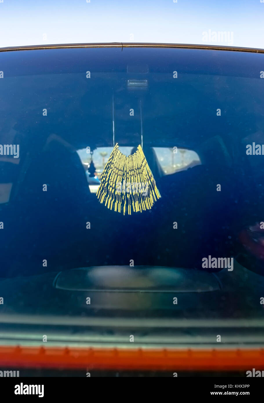 Air freshener hanging in the car on the rear view mirror. Custom cars