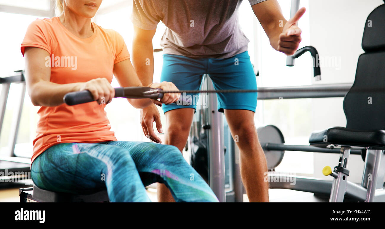 Personal trainer assisting woman lose weight Stock Photo Alamy