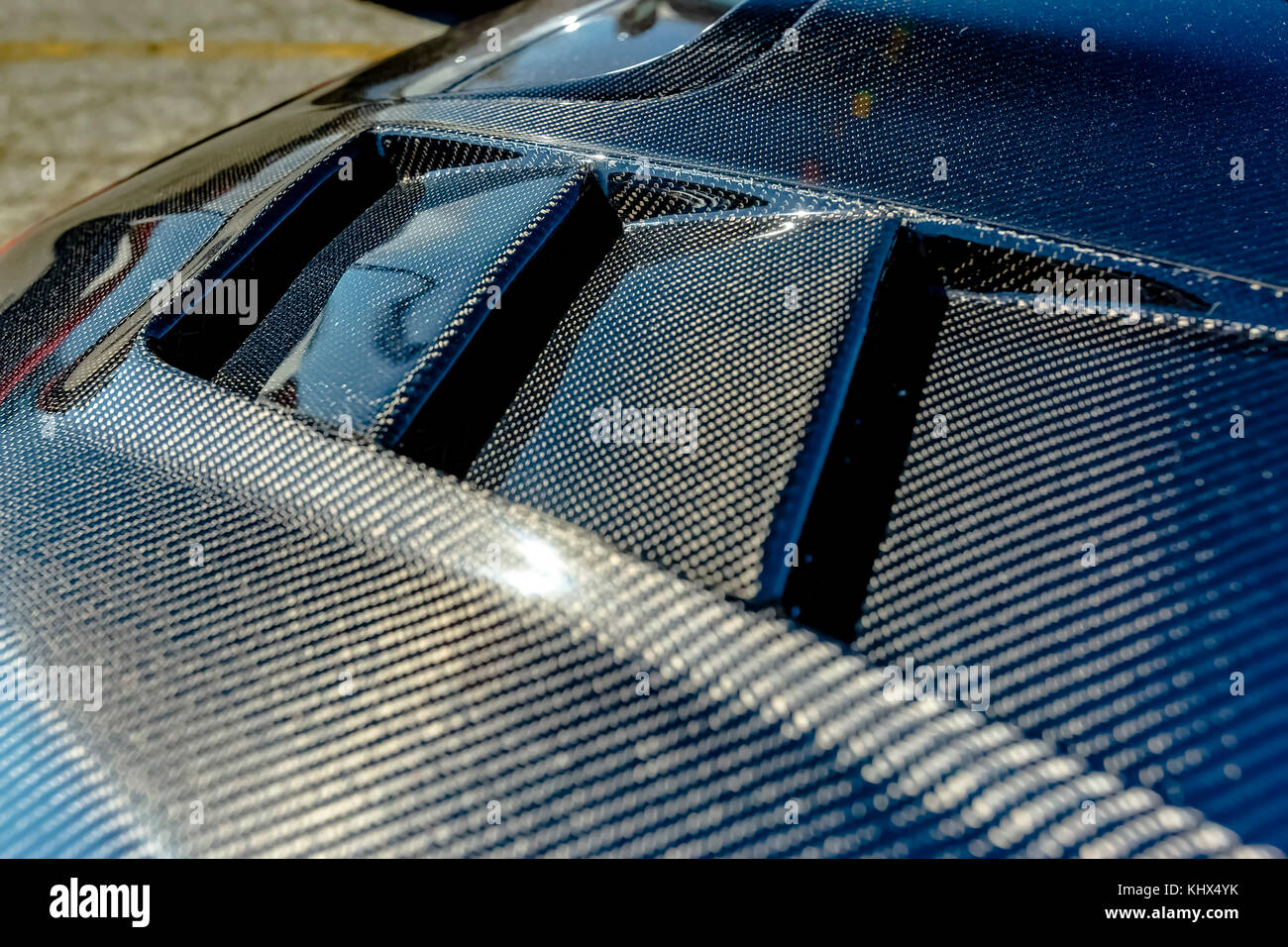 Kevlar carbon fiber texture on a car hood. Various vehicle details