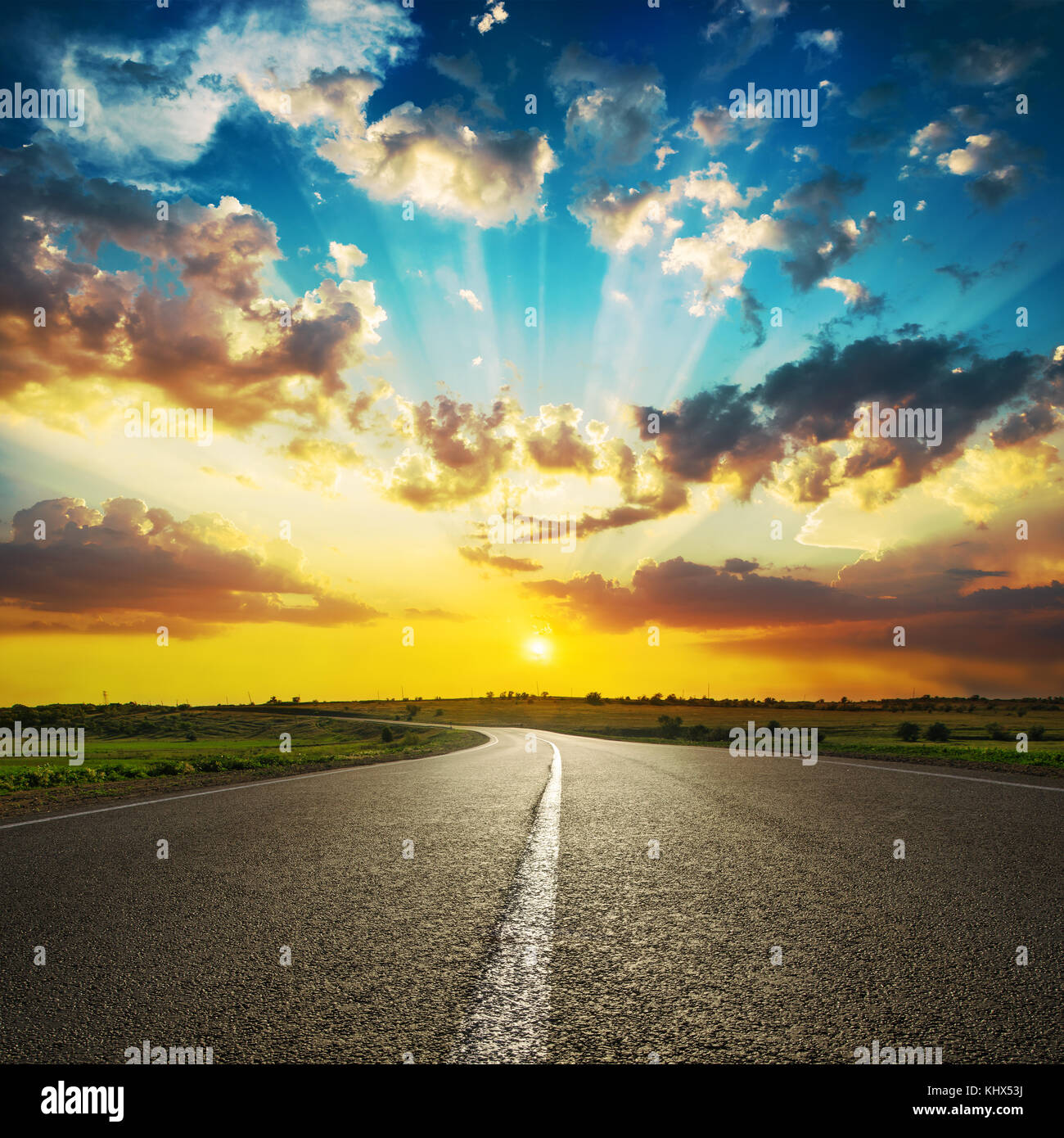 good sunset in clouds and asphalt road Stock Photo - Alamy