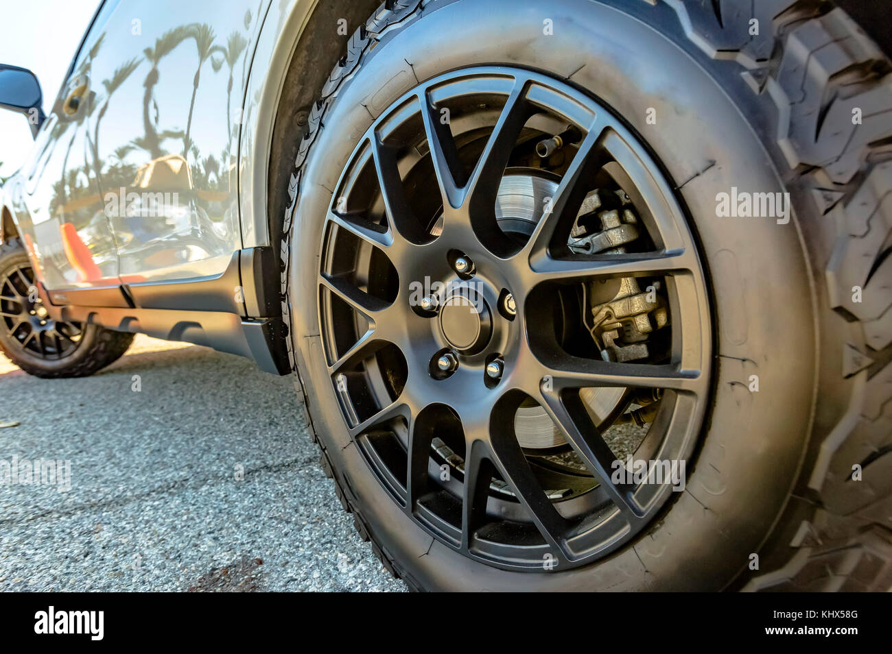 Offroad tires with black rims on a car ready for the trails. Orange