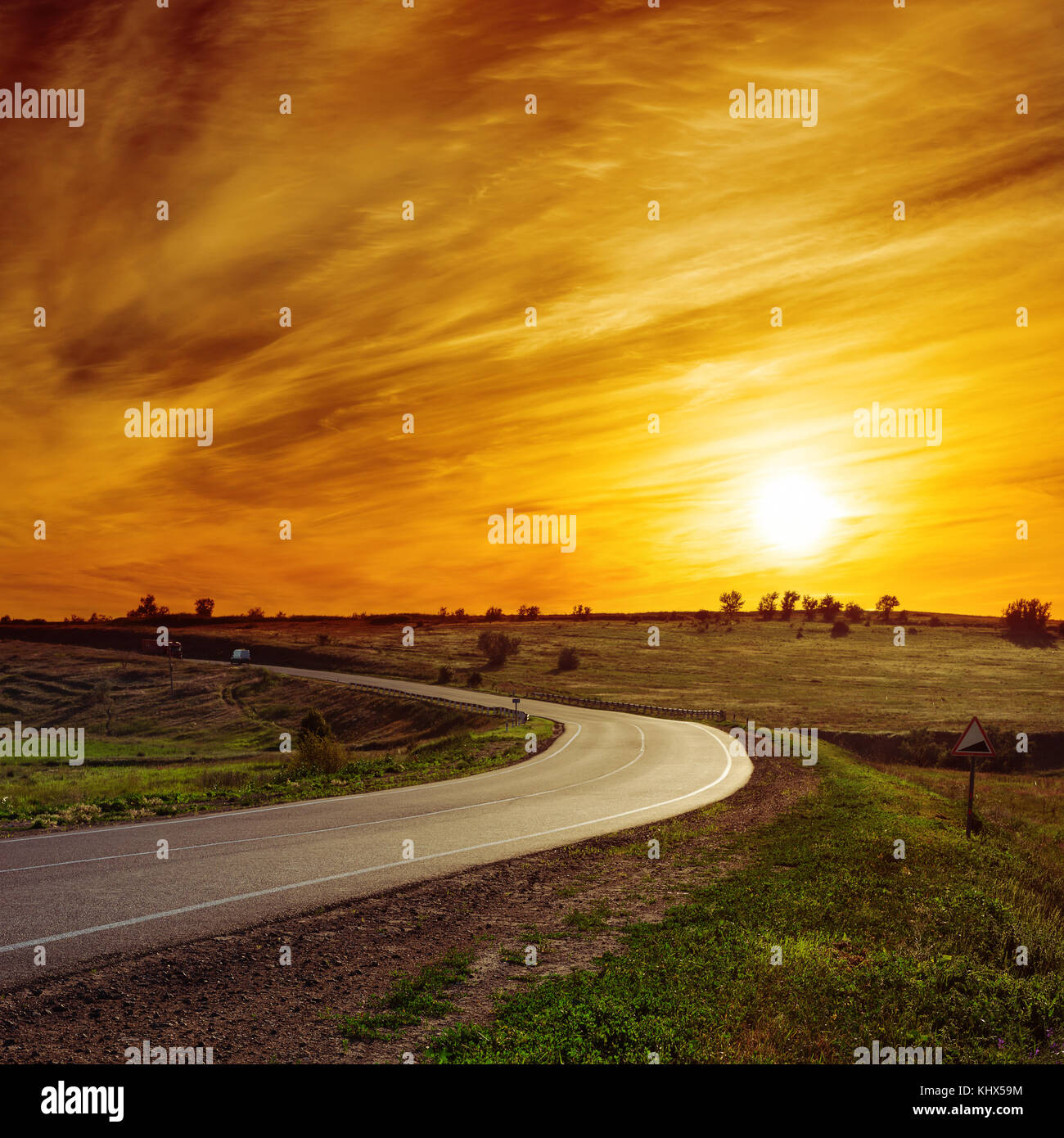 sun in orange sunset over asphalt road Stock Photo - Alamy