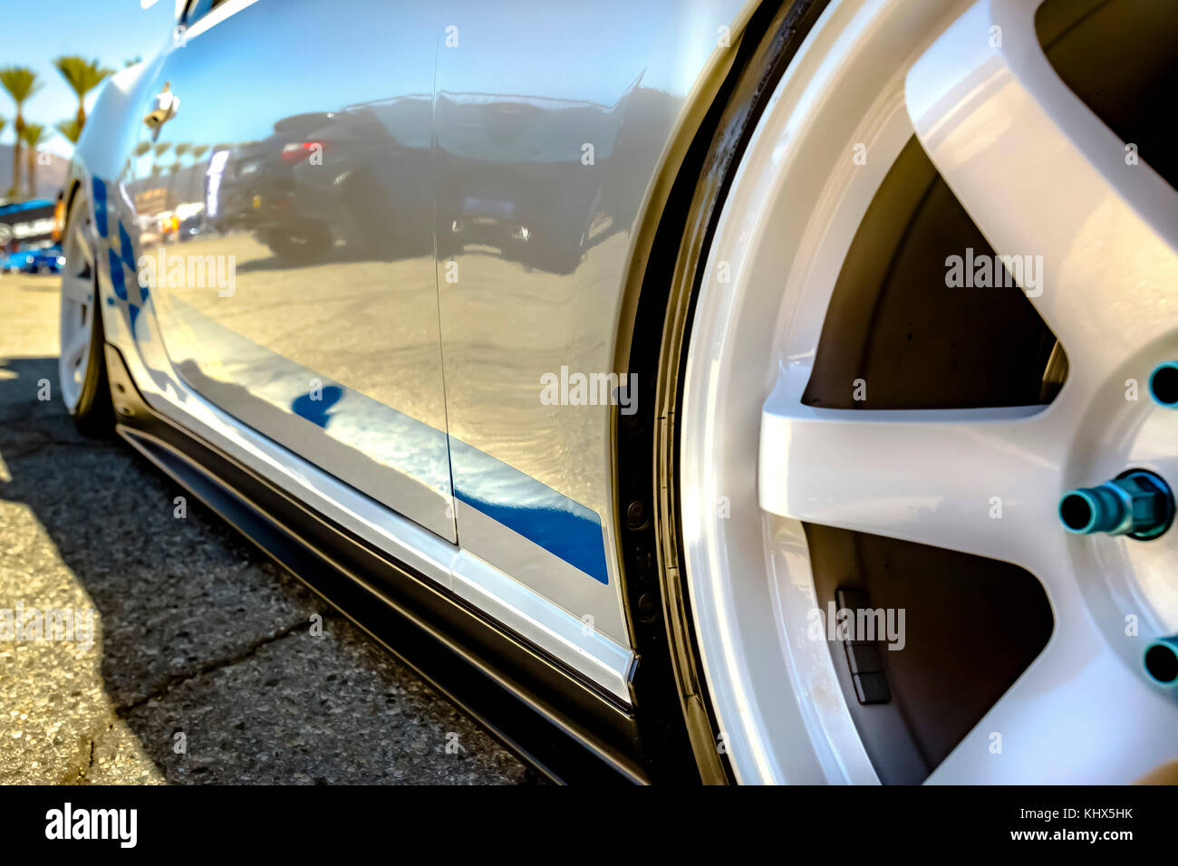 White rims with blue trimming of a close up on a car and wheels