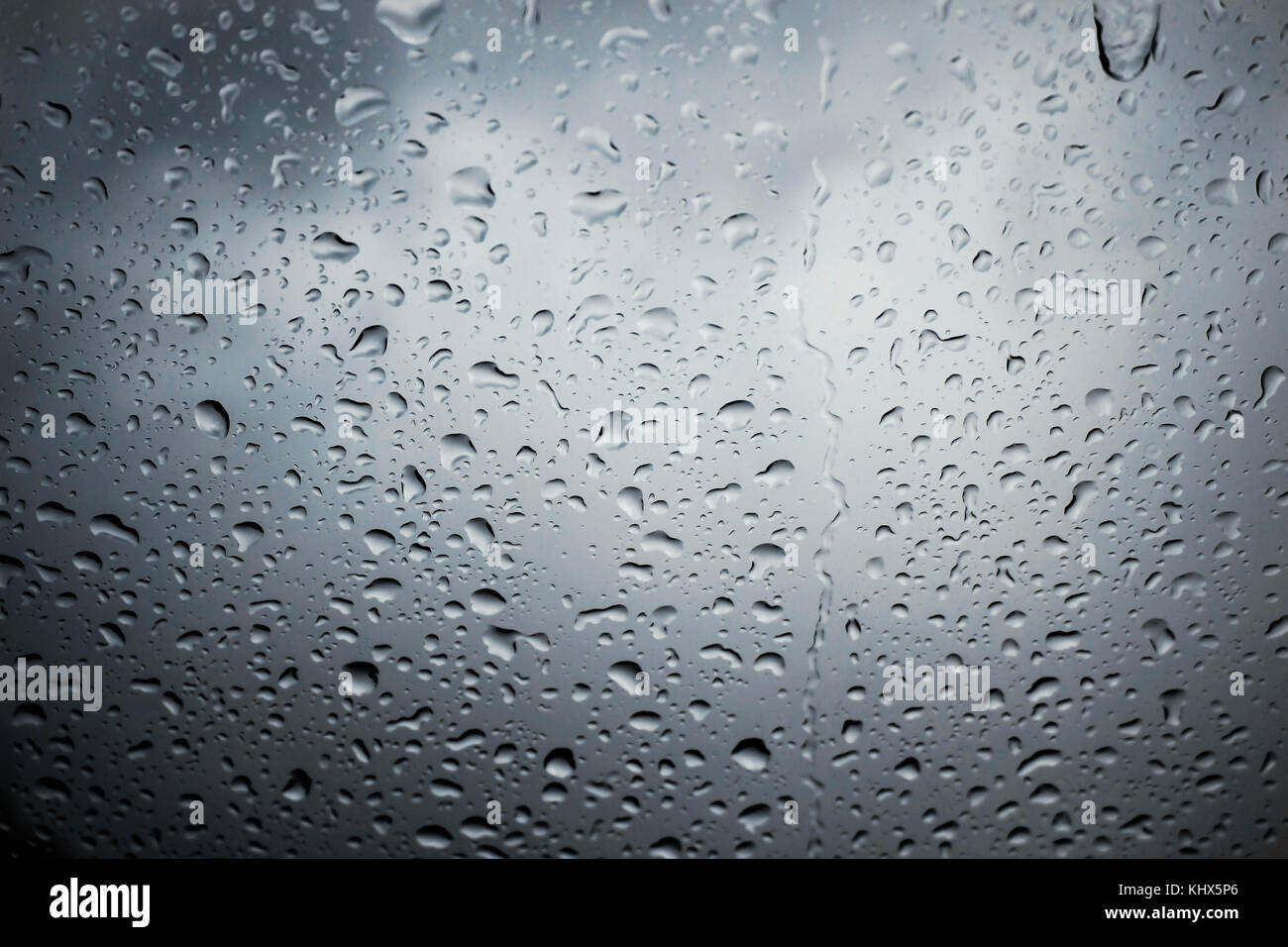 Water drops on glass with nature in rainy season Stock Photo - Alamy