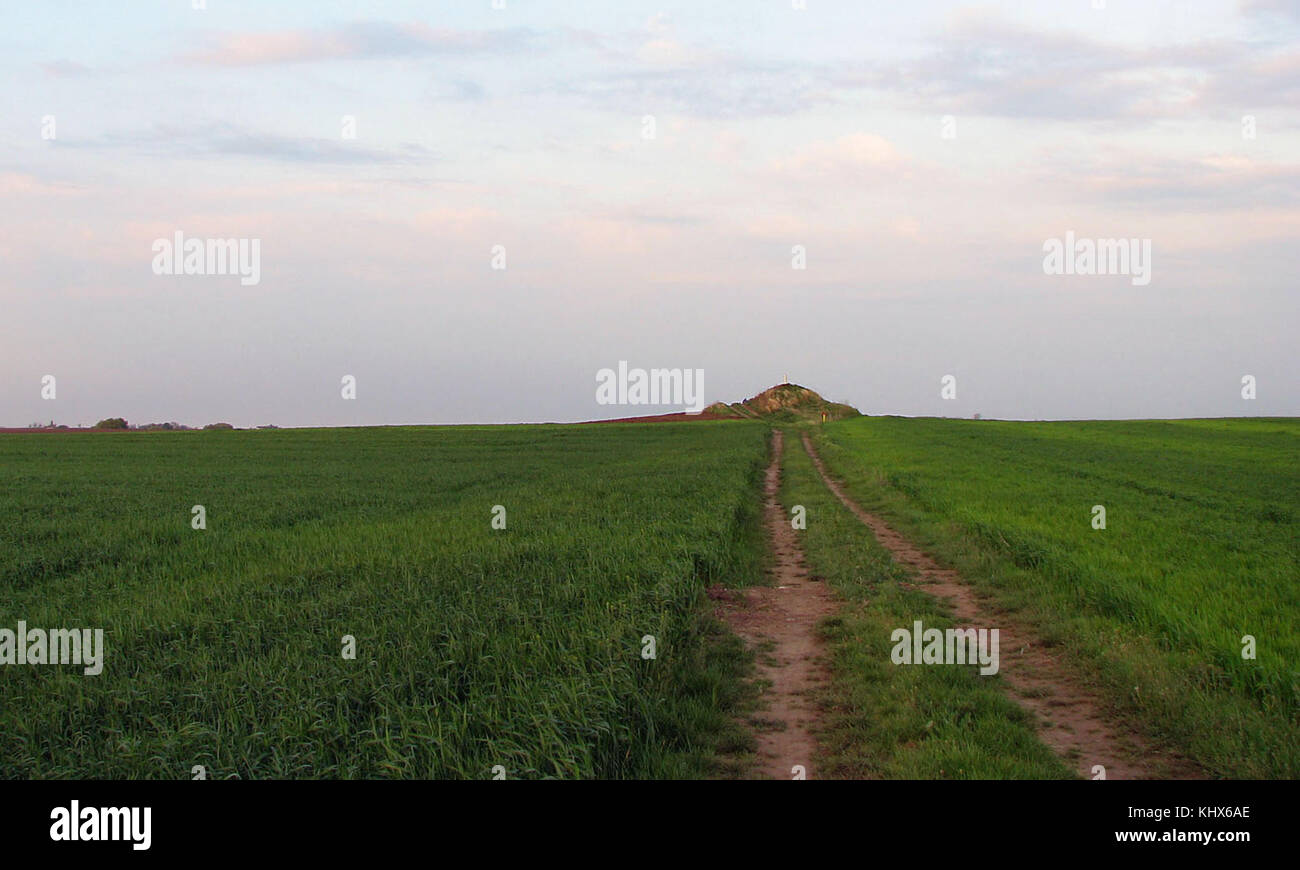 An old earth mound with three peaks (distant view Stock Photo Alamy