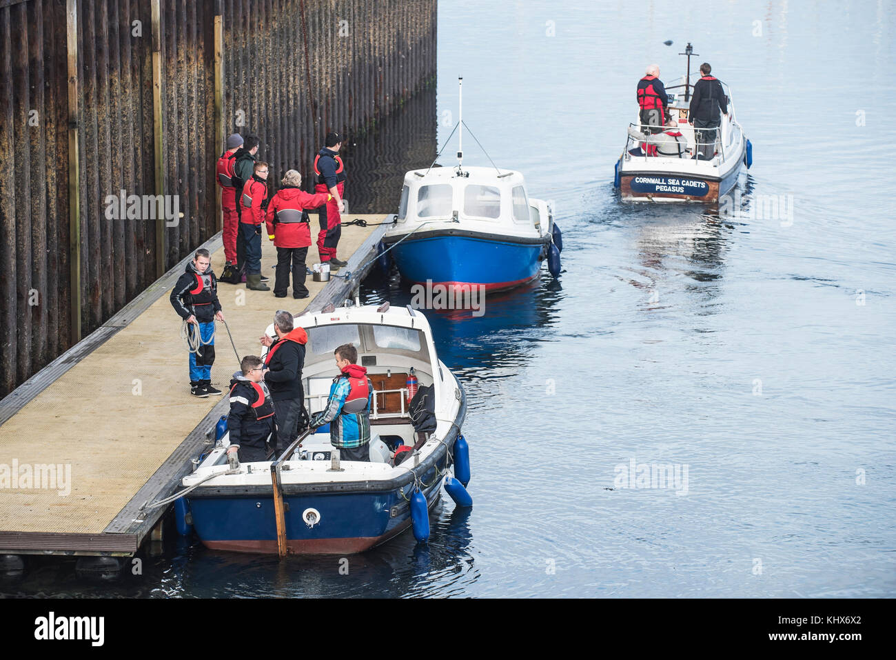 Cornwall Sea Cadets boarding small motor boats in preparation for a training exercise Falmouth