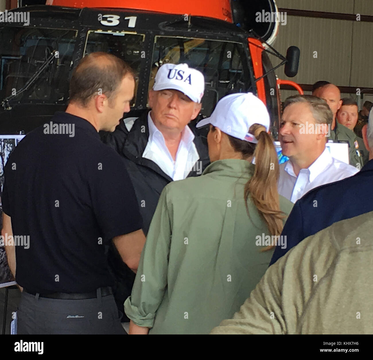 FORT MYERS, FL - SEPTEMBER 14: US President Donald Trump, with First Lady Melania Trump, Vice President Mike Pence and Florida Governor Rick Scott at Hangar Bay 3, Southwest Florida International Airport Fort Myers, Florida  prior to their tour of  the Naples Estates neighborhood that was damaged during Hurricane Irma September 14, 2017 in Fort Myers, Florida.    People:  Donald Trump, Melania Trump, Rick Scott, Mike Pence Stock Photo