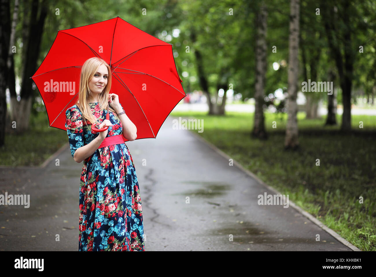 Girl in the street with an umbrella Stock Photo - Alamy