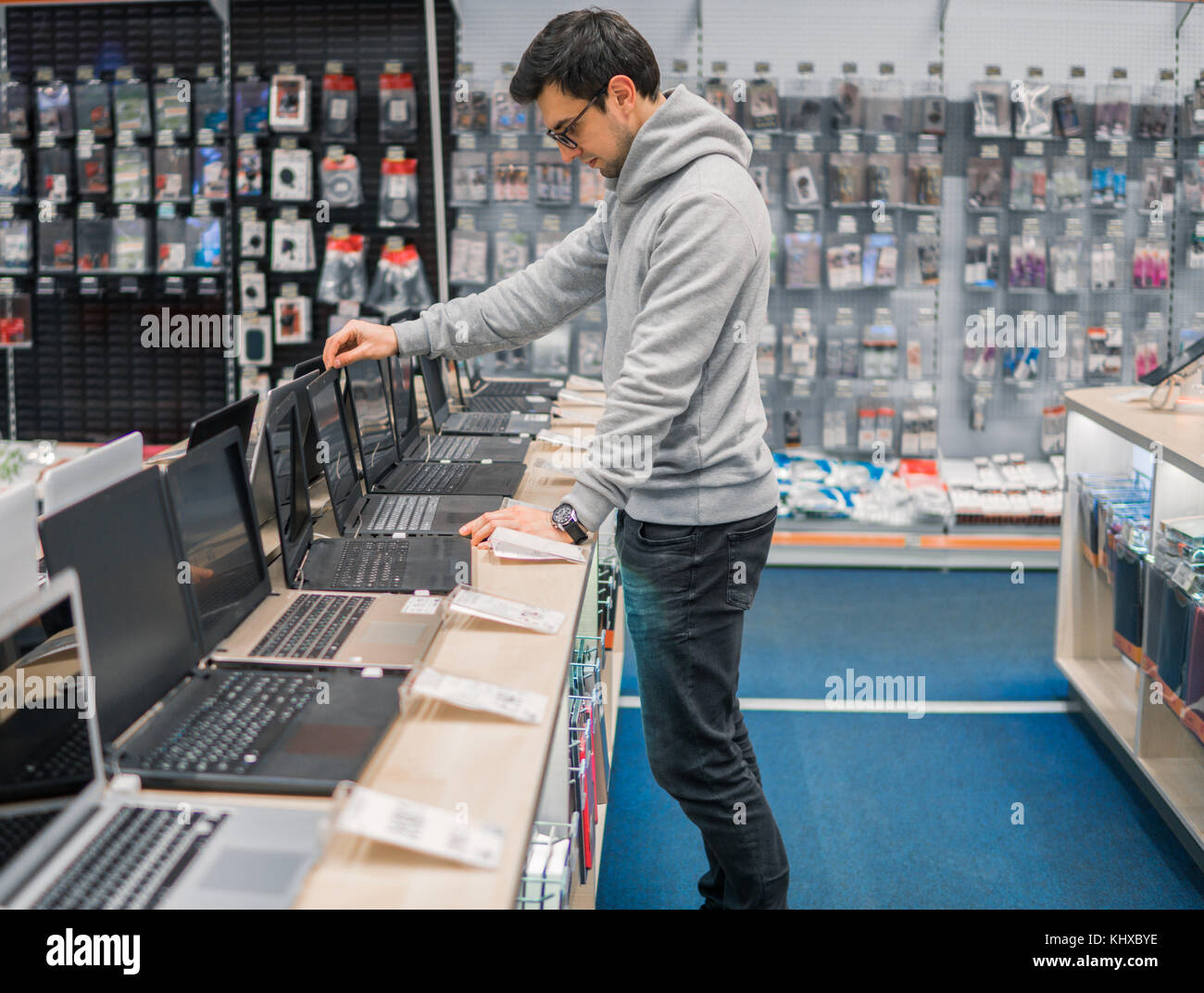 modern male customer choosing laptop in the computer shop Stock Photo -  Alamy