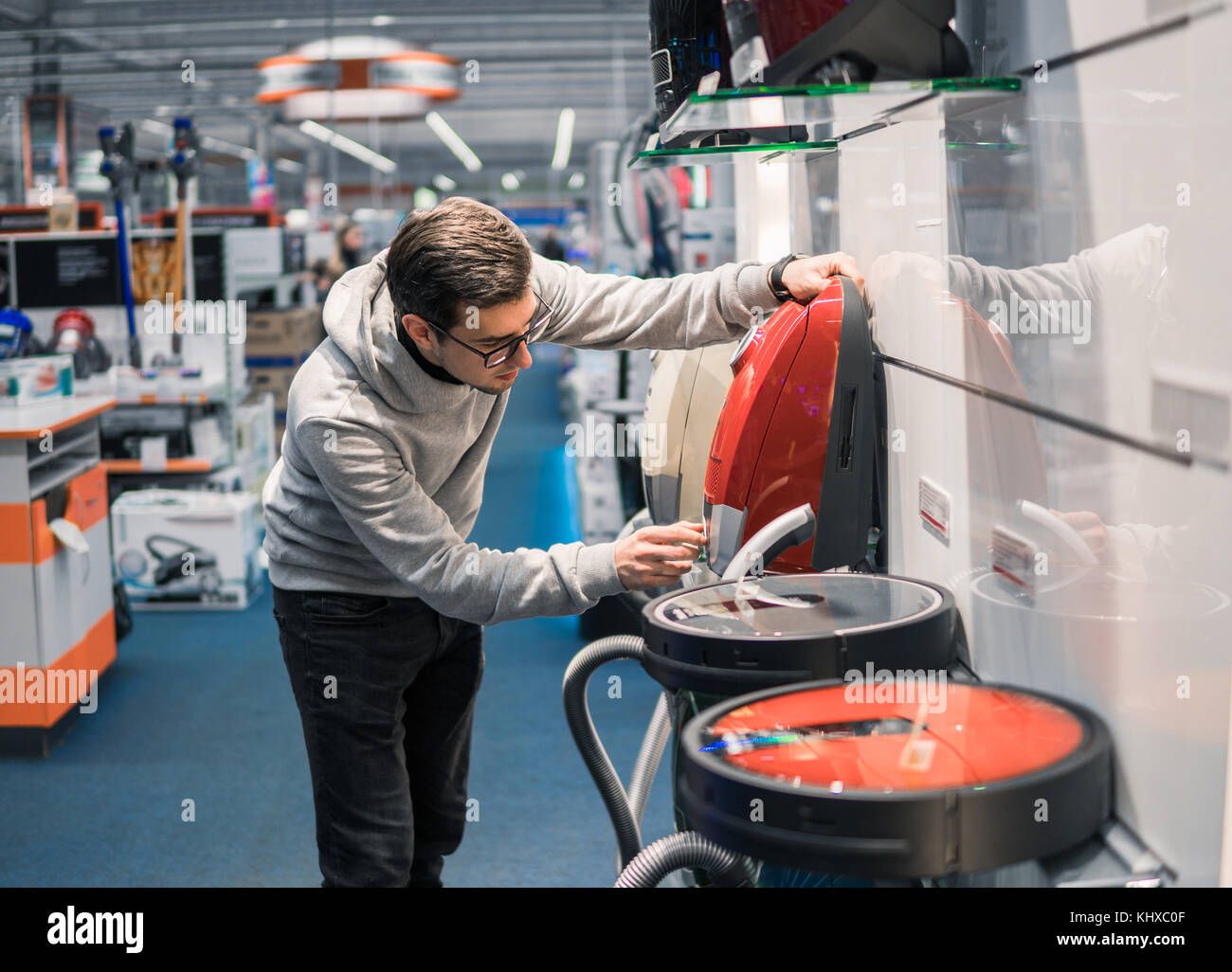 Smart customer buying new vacuum cleaner. Stock Photo