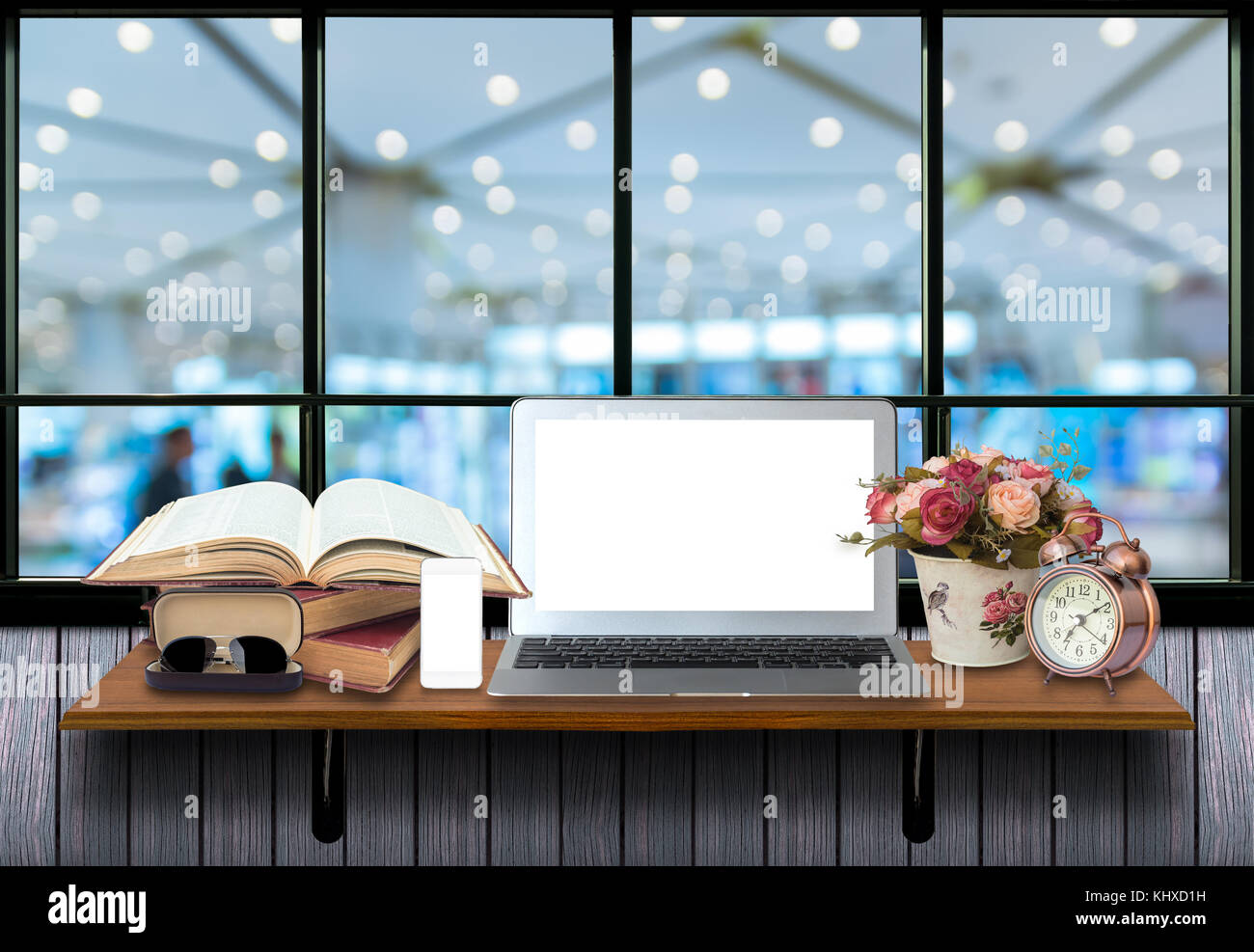 Top wooden shelves with computer laptop,smartphone, alarm clock and