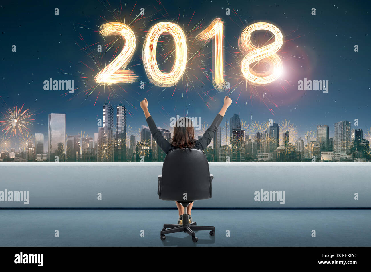 Back view of asian business woman looking 2018 firework sparkle on the ...