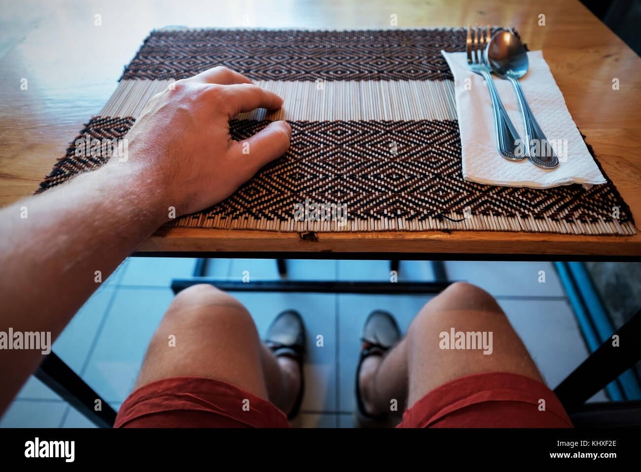 Man waiting for dinner in cafe. Folk and spoon lie near. View as it is selphie. Concept for diet Stock Photo