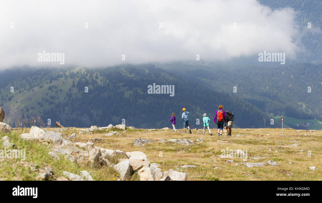 Nauders, Austria - August 9, 2017: People walking on a mountain road from the cable car station to the village of Nauders Stock Photo