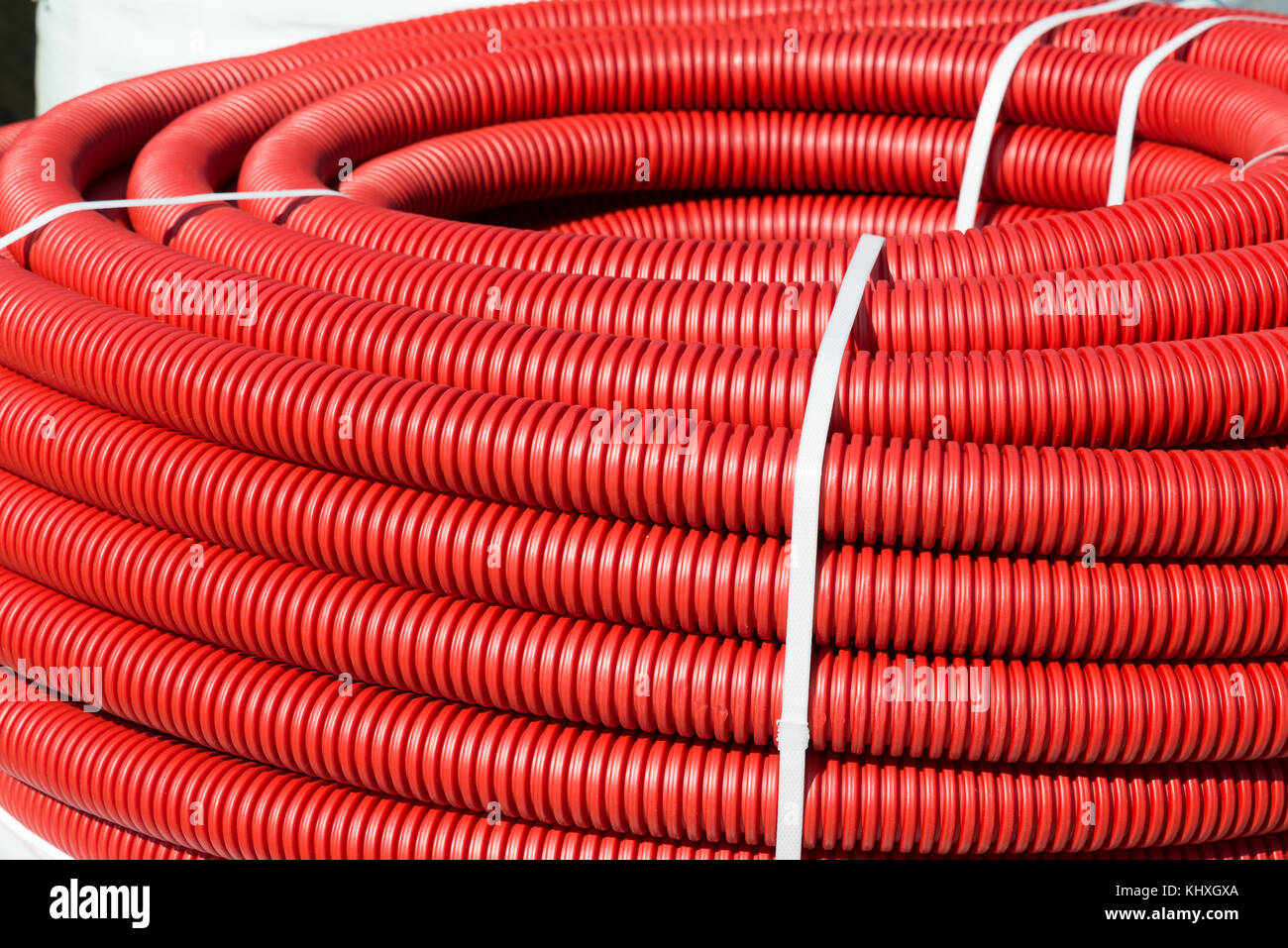 roll of red Flexible Plastic Pipes Stock Photo