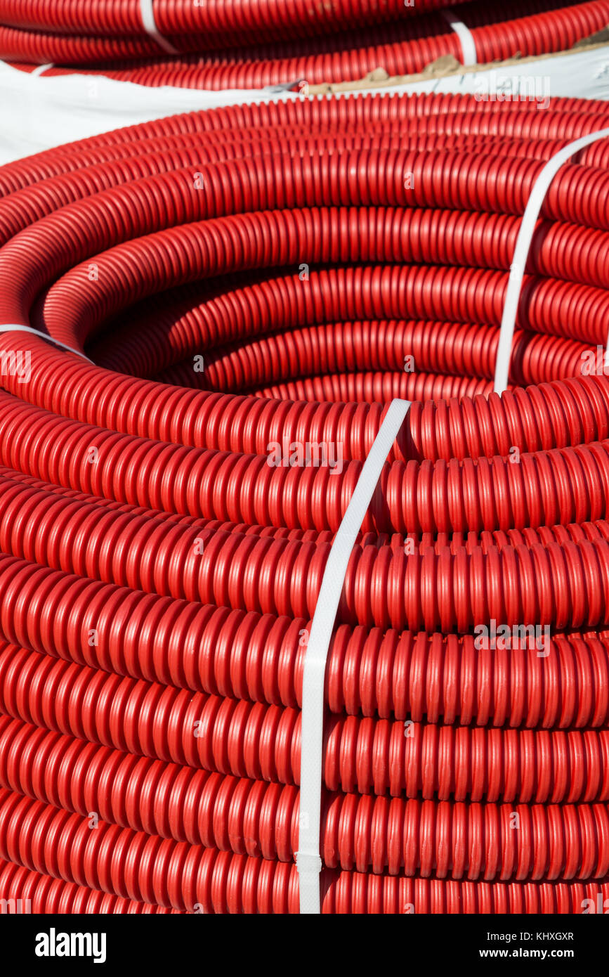 roll of red Flexible Plastic Pipes Stock Photo
