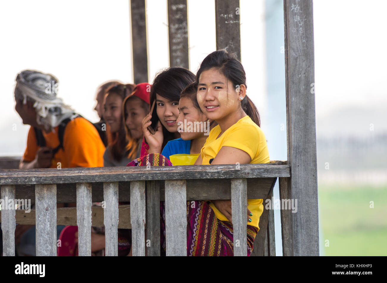 MANDALAY, MYANMAR - MARCH 13 : Unidentified Burmese women smiling at the ubein bridge on March 13, 2016 in Mandalay, Myanmar. The U-Bein bridge is the Stock Photo