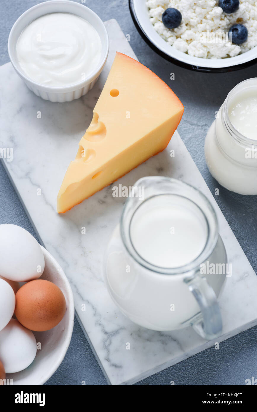 Milk, cheese, sour cream, eggs and yogurt. Dairy products on marble background. Selective focus