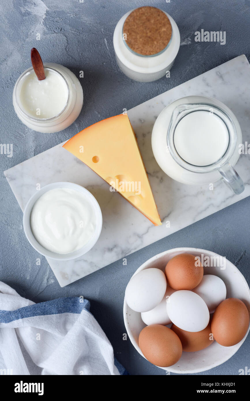 Selection of dairy products on marble background. Eggs, Cheese, Milk