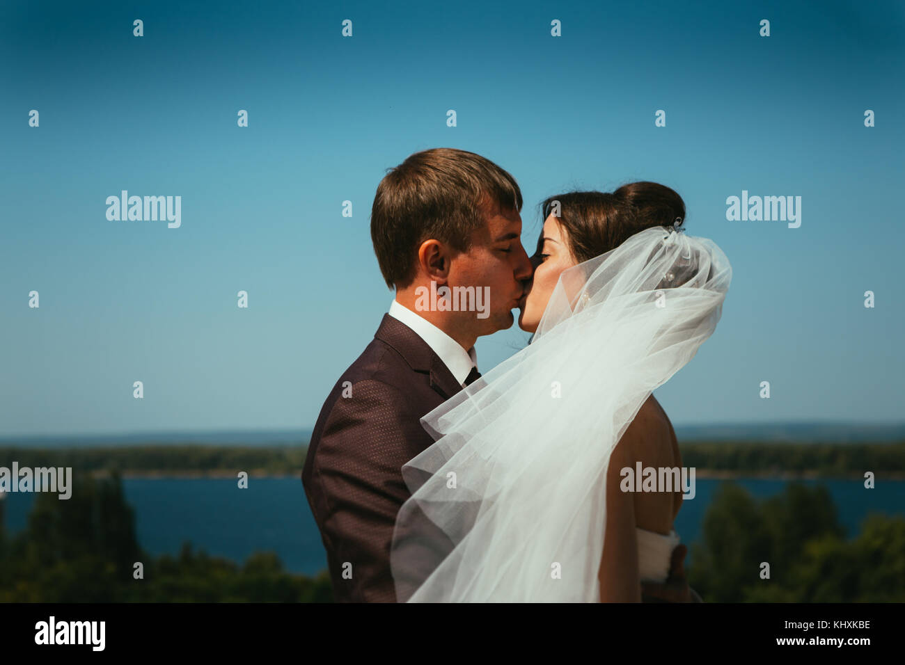 young bride and groom couple on the sky background Stock Photo - Alamy