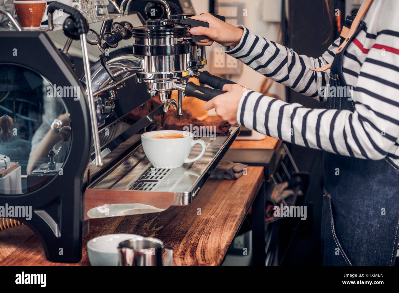 Close up woman barista making hot coffee with machine at counter bar in cafe  restaurant,Food and drink service concept Stock Photo - Alamy