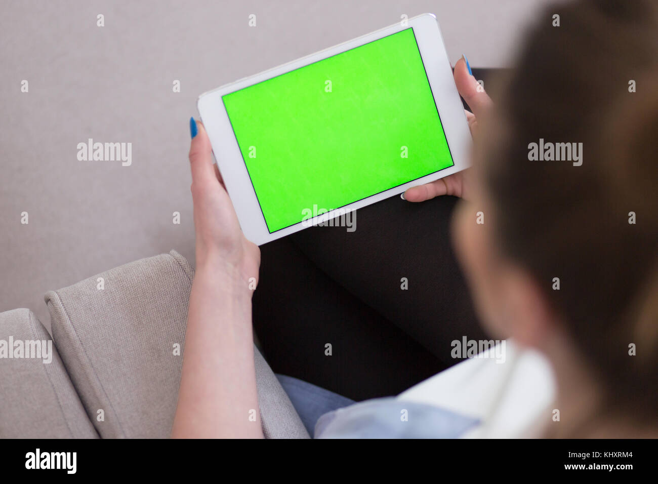 young happy woman on sofa using tablet computer at luxury home Stock ...