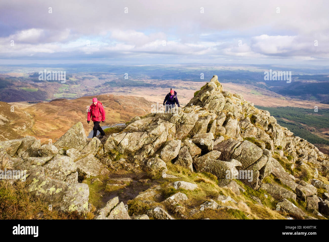 Hikers hiking up on Daear Ddu east ridge on Carnedd Moel Siabod mountain in mountains of Snowdonia National Park. Capel Curig Conwy Wales UK Britain Stock Photo